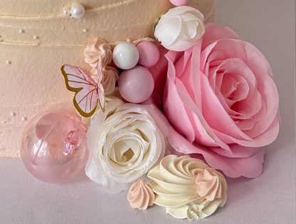 Close up of the pink rose, pastel spheres and meringue kisses at the base of the cake, custom cakes East London, Romford and Ilford.