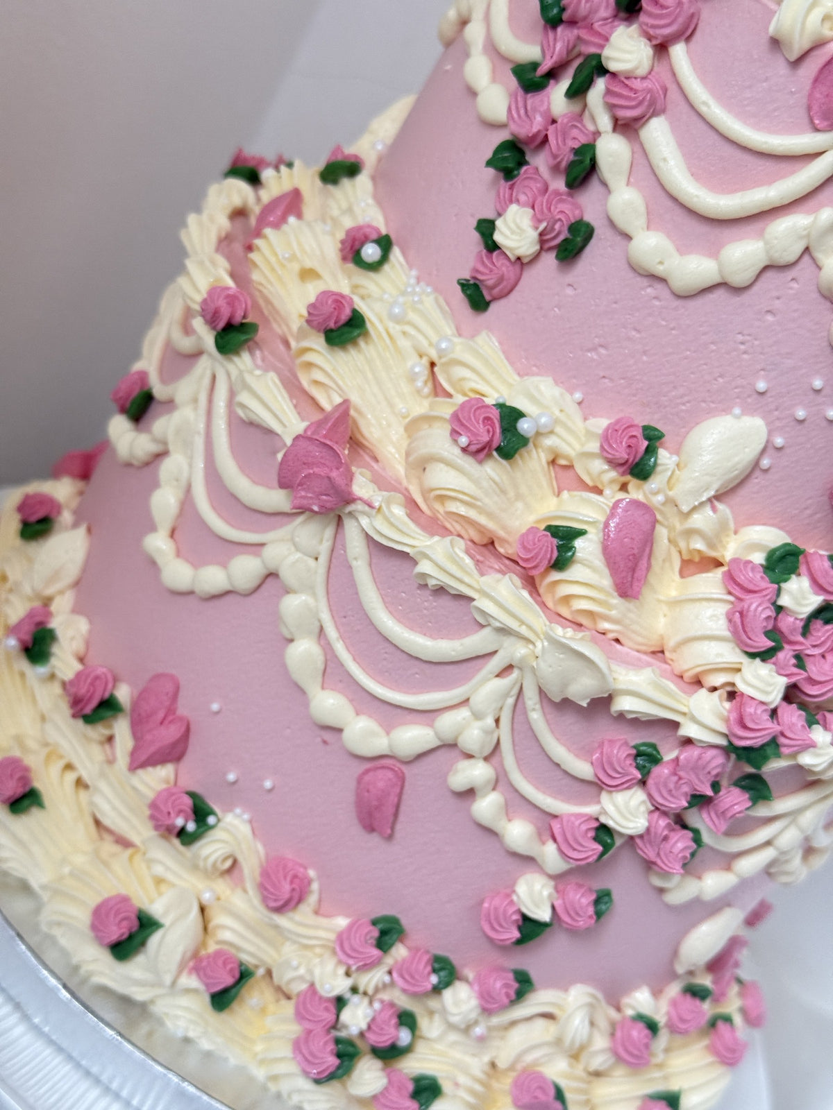 Detail of rosebuds, petals and scalloped drapes on the bottom tier, custom cakes East London, Romford and Ilford.