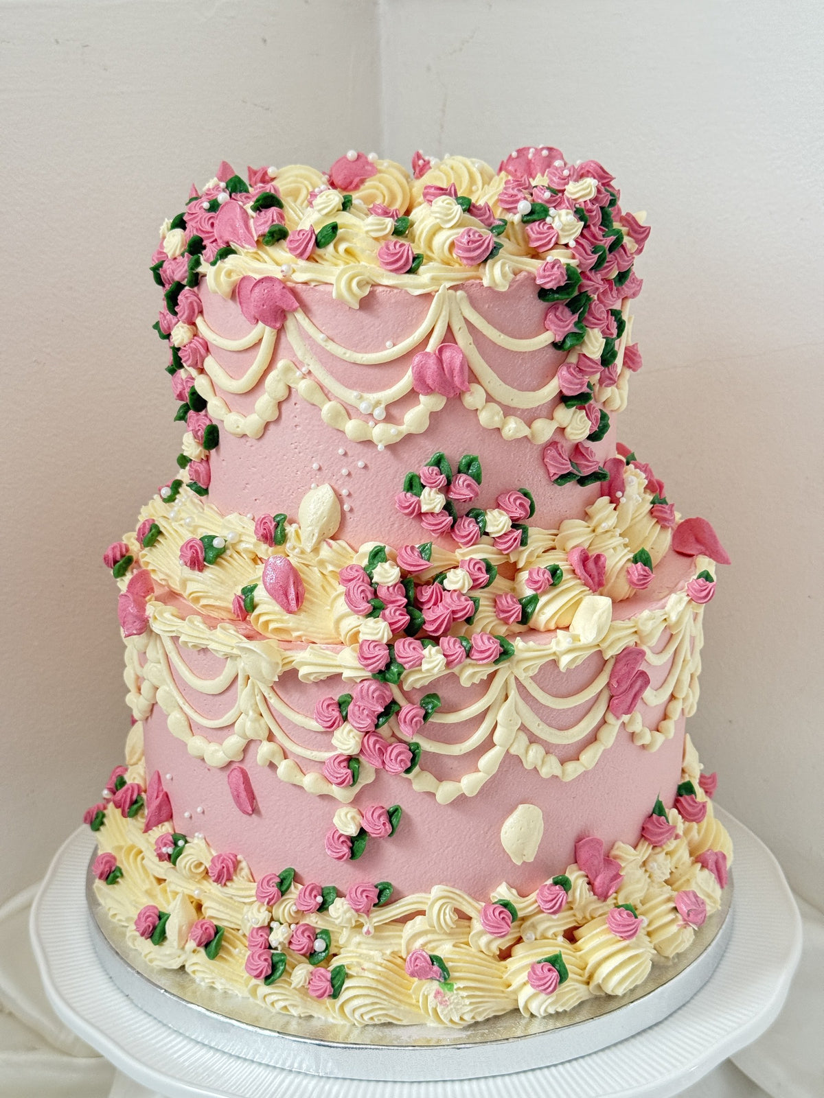 Two-tier dusky pink vintage Lambeth cake with cascading piped rosebuds, custom cakes East London, Romford and Ilford.