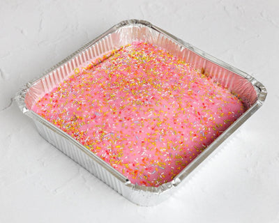 Pink school cake tray with pink icing and sprinkles, freshly baked for delivery across Romford, Ilford, Dagenham, and East London.