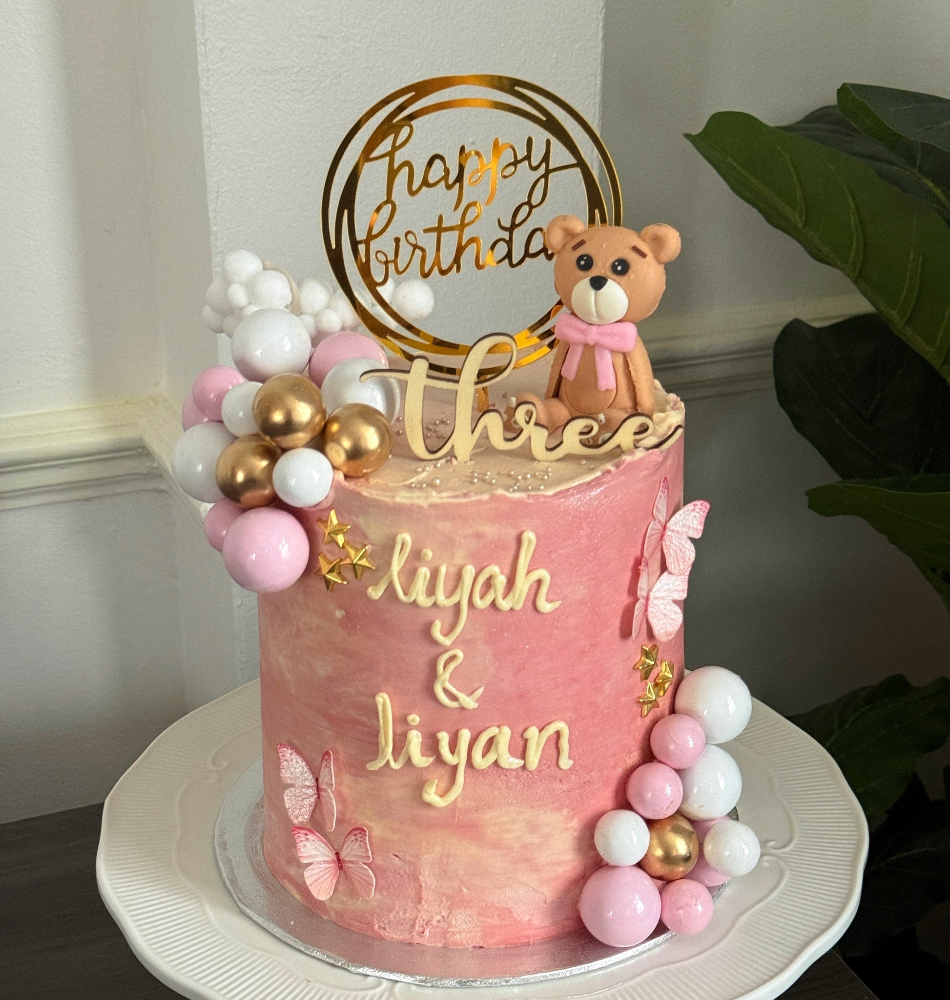 Pink watercolour teddy bear birthday cake with butterfly detailing, custom cakes East London, Romford and Ilford.