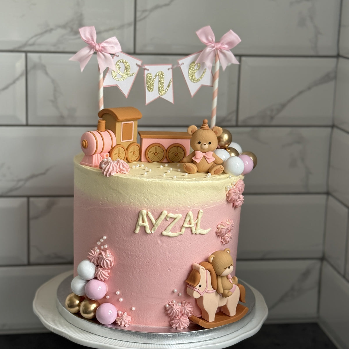 Side view of the pink ombre first birthday cake, custom cakes East London, Romford and Ilford.