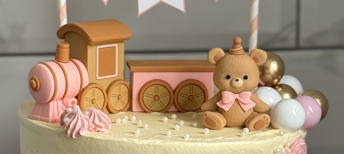 Close up of the toy train and teddy bear on top of the cake, custom cakes East London, Romford and Ilford.