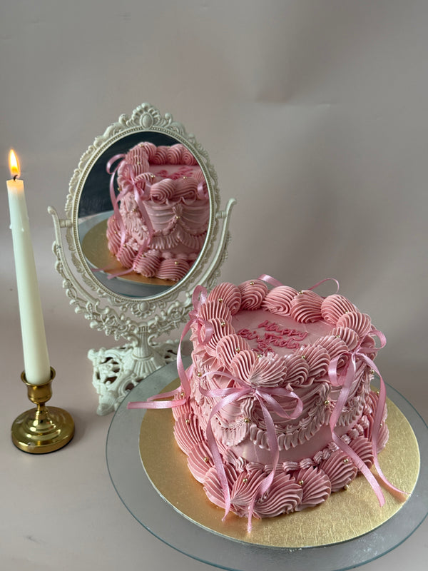 Pink vintage Lambeth birthday cake with piped bows for a birthday in Aldersbrook, Manor Park