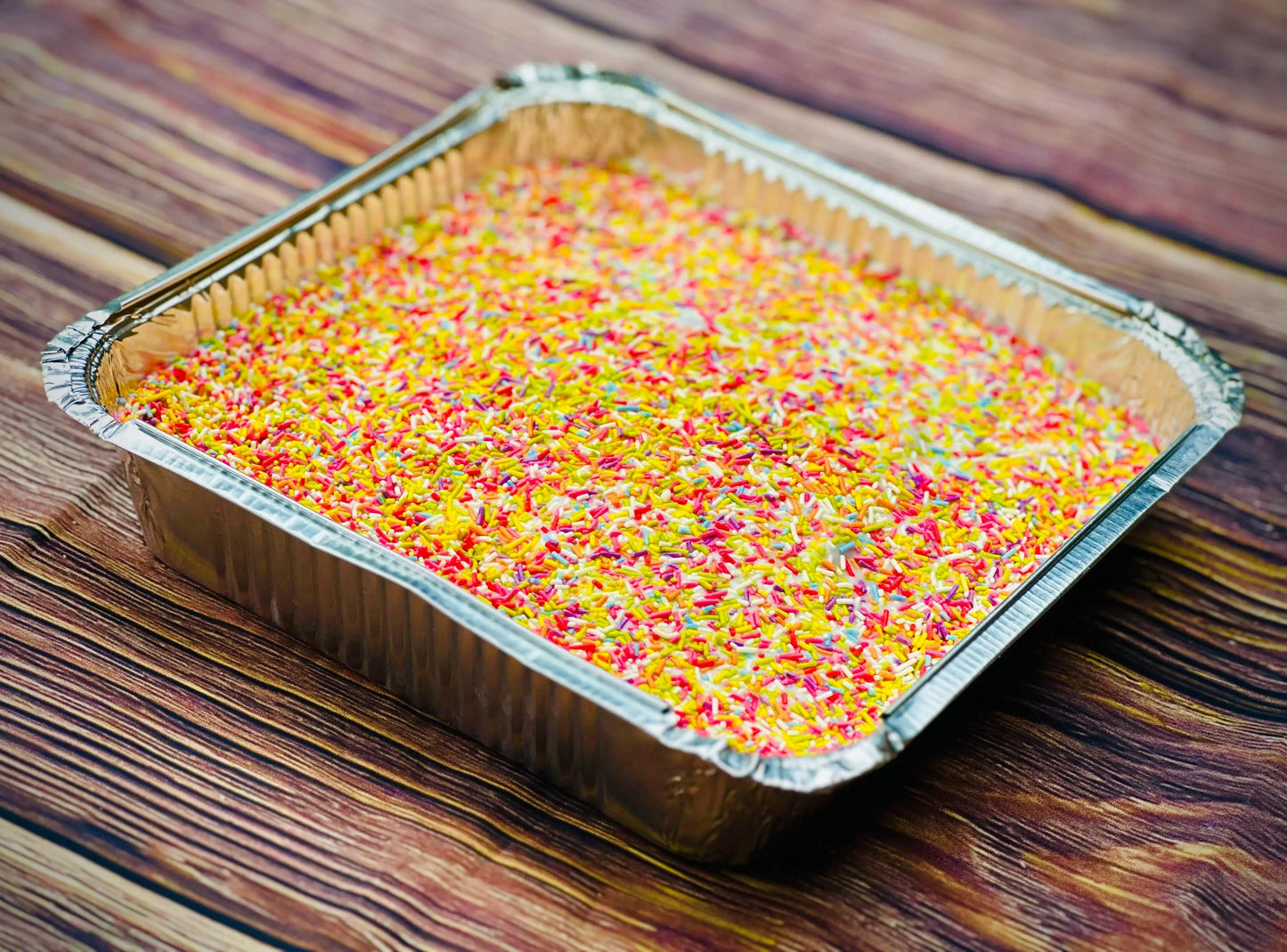 Retro school tray bake with pink icing and coloured sprinkles, ready for next day delivery to Walthamstow and Stratford in East London.