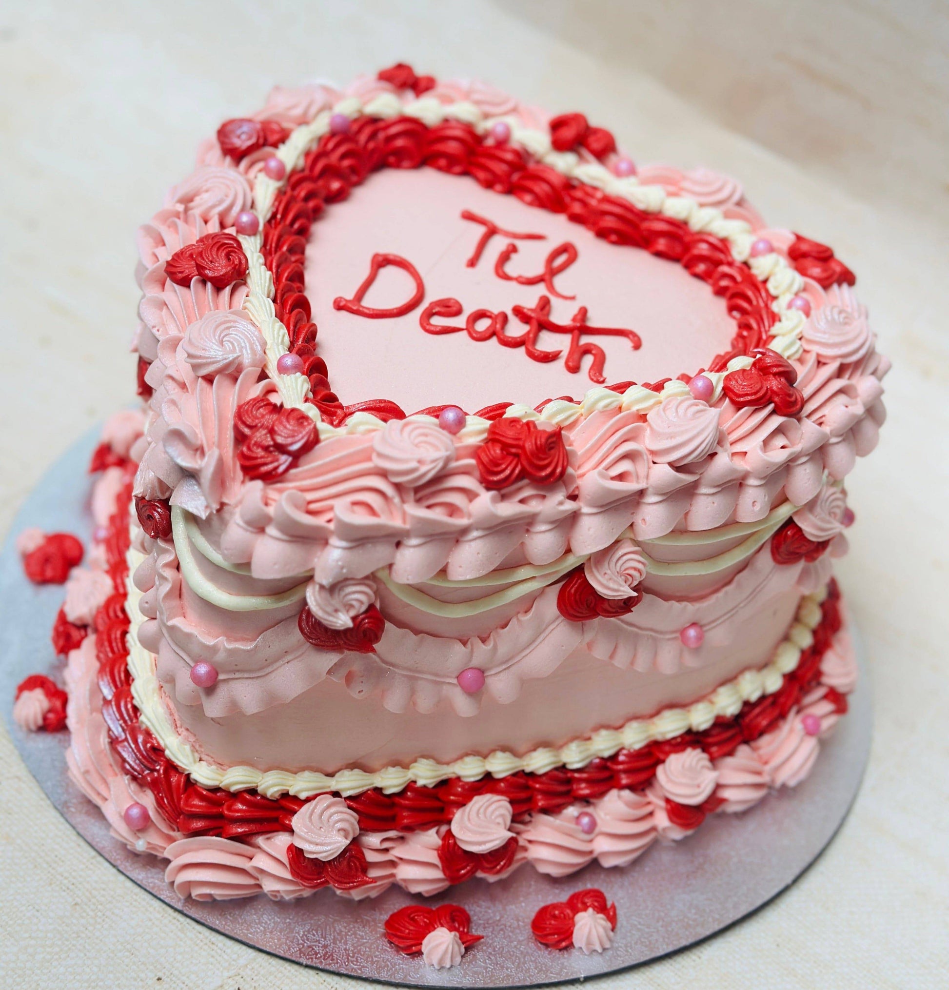 Same-day Til Death heart cake delivery in Stratford and South Woodford – striking design with red roses and piping.