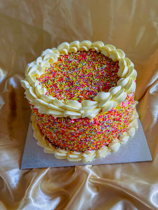 Sprinkle birthday cake on vanilla sponge, same day delivery in Stratford and East London.