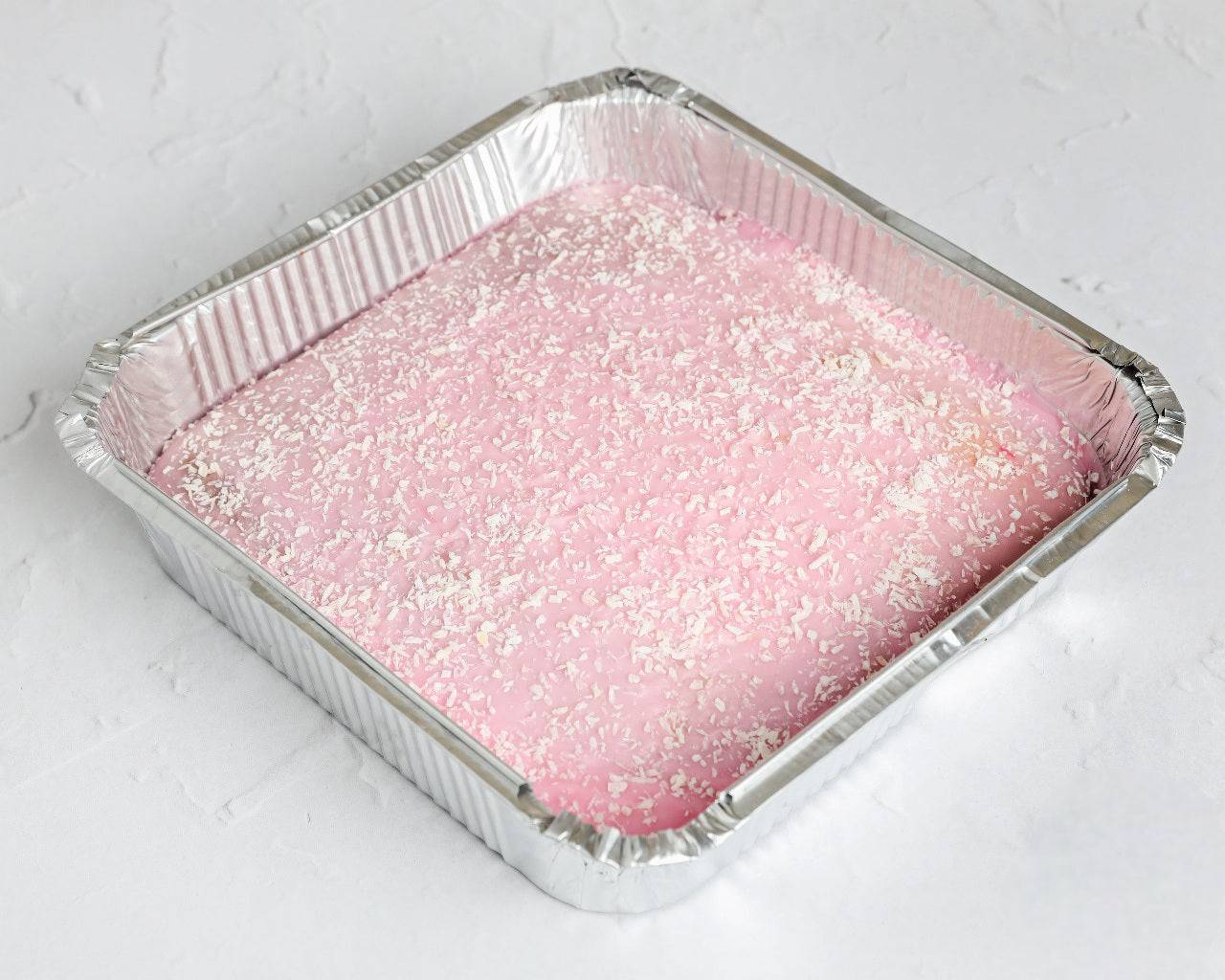 Tottenham cake tray with pink icing and coconut topping, freshly baked and available for same day delivery in Romford and Ilford, East London.