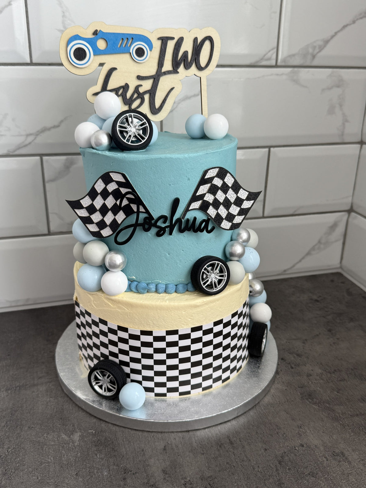 Angled view of the two-tier race car birthday cake, custom cakes East London, Romford and Ilford.