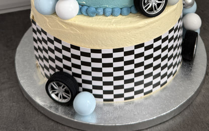 Close up of the checkered bottom tier and toy wheels, custom cakes East London, Romford and Ilford.