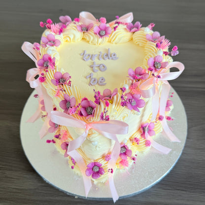 Bridal shower heart-shaped cake with pink bows and buttercream piping – Dagenham East Ham