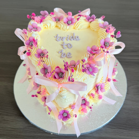 Bridal shower heart-shaped cake with pink bows and buttercream piping – Dagenham East Ham