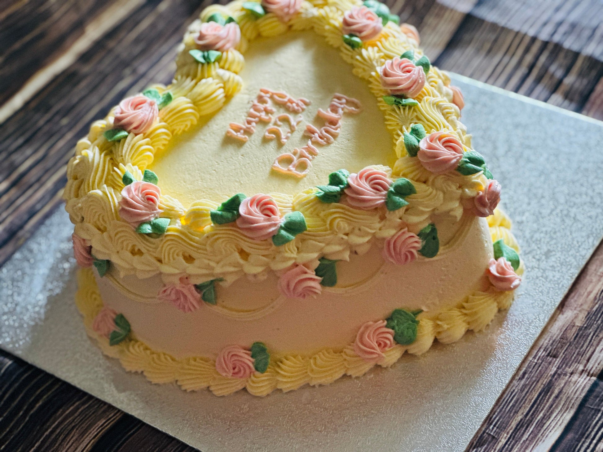 Vintage Heart Cake CT40 with yellow buttercream and pink roses, personalised for delivery in London.