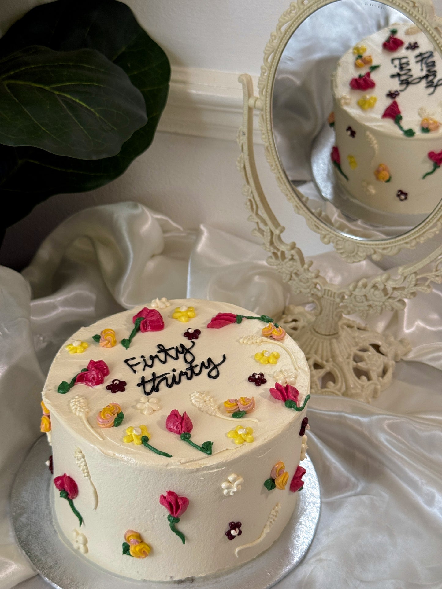 Close up of hand piped wildflowers on white buttercream cake, custom cakes East London, Romford and Ilford.
