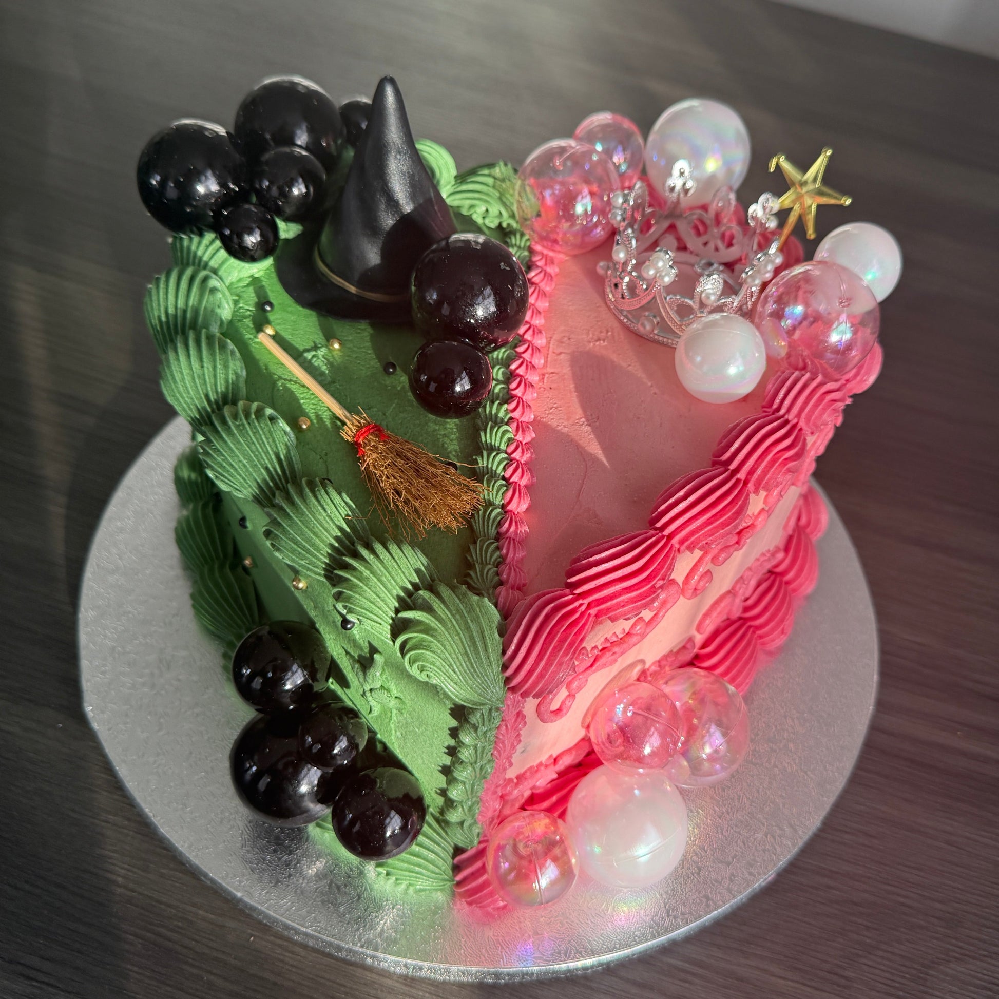 Wicked inspired half-and-half heart cake with witch and princess design delivered in East London and Ilford