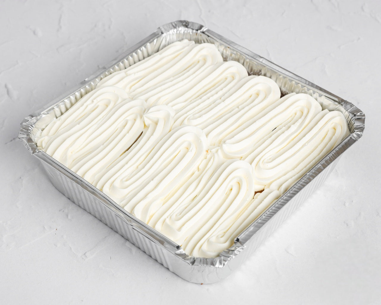 Vanilla Milk Cake Tray with whipped cream topping in aluminium tray – same-day cake delivery in Romford and Ilford, East London.